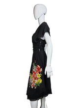 Load image into Gallery viewer, Black dress with floral design on a mannequin against a plain wall.
