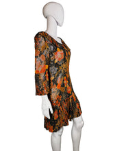 Load image into Gallery viewer, Mannequin wearing a floral dress with orange and black pattern against a plain wall.

