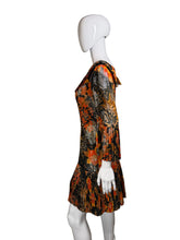 Load image into Gallery viewer, Mannequin wearing a colorful dress with abstract patterns on a plain background
