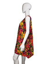 Load image into Gallery viewer, Mannequin wearing a colorful floral dress against a plain wall.
