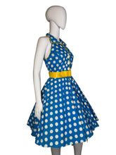Load image into Gallery viewer, Mannequin wearing a blue dress with white polka dots and a yellow belt on a plain background
