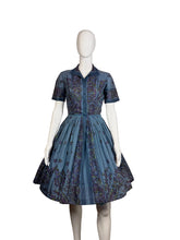 Load image into Gallery viewer, Mannequin wearing a blue patterned dress against a plain wall.
