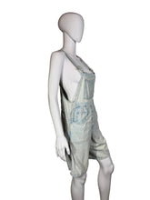 Load image into Gallery viewer, Mannequin wearing light blue denim overalls against a plain wall.
