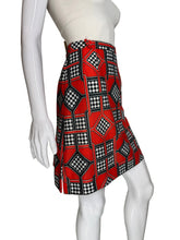 Load image into Gallery viewer, Mannequin wearing a white top and red patterned skort on a plain background.

