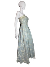 Load image into Gallery viewer, Mannequin wearing a floral dress against a white wall.
