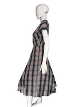 Load image into Gallery viewer, Mannequin wearing a plaid dress against a plain wall.
