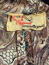 Load image into Gallery viewer, Close-up of a patterned fabric with a visible label.
