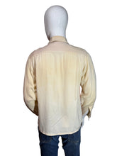Load image into Gallery viewer, Mannequin wearing a button up shirt showcasing the tan back
