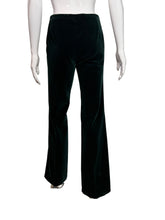Load image into Gallery viewer, Dark green velvet pants displayed on  a mannequin against a neutral background
