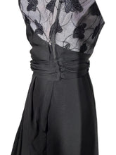 Load image into Gallery viewer, Side view of a black dress with lace detailing on a white background
