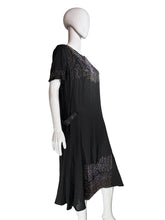 Load image into Gallery viewer, Black dress on a mannequin against a plain wall
