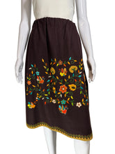 Load image into Gallery viewer, Mannequin wearing a brown skirt with colorful floral embroidery against a plain background.
