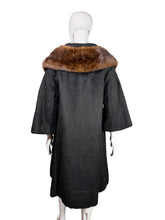 Load image into Gallery viewer, Black coat with brown fur collar on a mannequin against a neutral background
