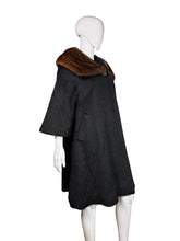 Load image into Gallery viewer, Black coat with brown fur collar on a mannequin against a neutral background
