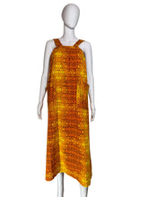 Load image into Gallery viewer, Mannequin wearing an orange patterned dress against a plain wall.

