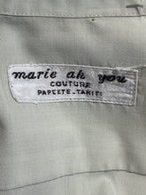 Load image into Gallery viewer, Close-up of a label on a garment with text
