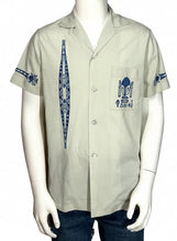 Load image into Gallery viewer, Light gray shirt with blue patterns on a mannequin against a gray background
