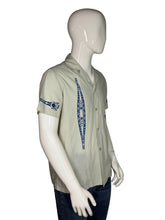 Load image into Gallery viewer, Light gray shirt with blue patterns on a mannequin against a gray background
