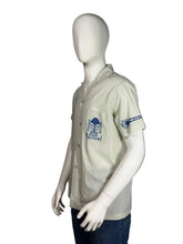 Load image into Gallery viewer, Light gray shirt with blue patterns on a mannequin against a gray background

