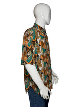 Load image into Gallery viewer, Mannequin wearing a patterned shirt with a brown and teal geometric design

