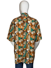 Load image into Gallery viewer, Mannequin wearing a patterned shirt with a brown and teal geometric design
