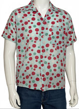 Load image into Gallery viewer, Mannequin wearing a colorful polka dot smiley face shirt with a plain background
