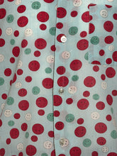 Load image into Gallery viewer, Patterned fabric with red, green, and white polka dots on a light blue background
