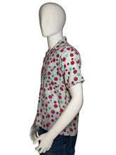 Load image into Gallery viewer, Mannequin wearing a colorful polka dot smiley face shirt with a plain background
