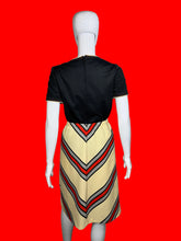 Load image into Gallery viewer, Mannequin wearing a set featuring a black top and a chevron skirt
