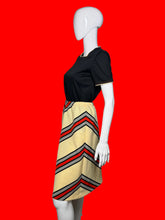 Load image into Gallery viewer, Mannequin wearing a set featuring a black top and a chevron skirt
