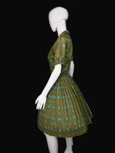 Load image into Gallery viewer, Green and blue patterned dress on a mannequin 
