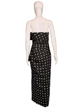 Load image into Gallery viewer, Black polka dot dress on a mannequin.
