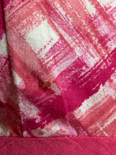 Load image into Gallery viewer, Close-up of pink and white checkered fabric with a small stain on it.
