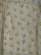 Load image into Gallery viewer, Floral patterned fabric with small flowers on a beige background
