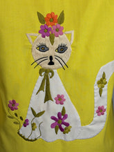 Load image into Gallery viewer, Embroidered design of a cat with flowers on a yellow fabric background
