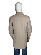 Load image into Gallery viewer, A beige long-sleeve  jacket displayed on a white mannequin torso, with blue jeans partially visible underneath
