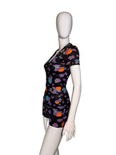 Load image into Gallery viewer, A black short-sleeve romper in side profile view
