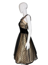 Load image into Gallery viewer, Mannequin wearing a black dress with gold polka dots on a white surface.
