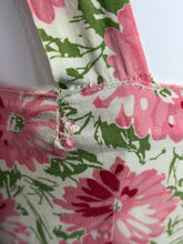Load image into Gallery viewer, Close-up of a dress strap on a white background showing some damage
