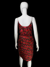 Load image into Gallery viewer, A sleeveless red and black floral print dress displayed on a white mannequin.
