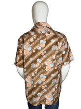 Load image into Gallery viewer, Mannequin wearing a patterned shirt on a plain background
