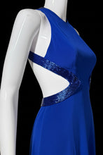 Load image into Gallery viewer, A close-up of a royal blue satin-like fabric draped over a white mannequin torso, with a sparkly blue sequined trim detail visible along the edge.
