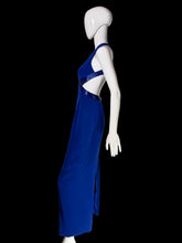 Load image into Gallery viewer, A royal blue sleeveless maxi dress with a cutout waist and shoulder detail, displayed on a white mannequin.
