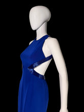 Load image into Gallery viewer, A royal blue sleeveless dress displayed on a white mannequin, featuring a V-neckline with a textured, sparkly blue trim.
