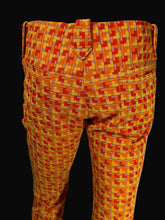 Load image into Gallery viewer, Patterned trousers on a white mannequin featuring a geometric woven design in orange, yellow, and red with thin blue accent lines.
