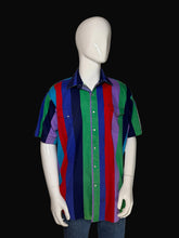 Load image into Gallery viewer, A multicolor short-sleeve button-up shirt with vertical stripes in blue, green, red, and purple, displayed on a white mannequin with jeans against a black background.
