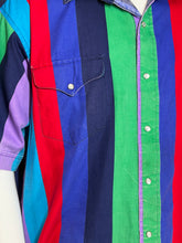 Load image into Gallery viewer, A close-up of a striped button-up shirt with horizontal bands of red, green, navy blue, royal blue, and light blue, featuring a chest pocket with white buttons.
