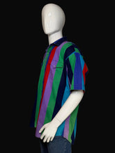 Load image into Gallery viewer, A multicolor striped short-sleeve button-up shirt displayed on a white mannequin, paired with blue jeans against a black background.

