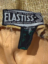 Load image into Gallery viewer, Close-up of a Elastiss label on a textured fabric background
