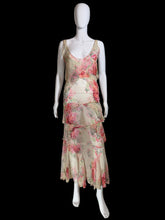 Load image into Gallery viewer, A sleeveless tiered maxi dress with a pink and red floral print on a beige base, displayed on a white mannequin.
